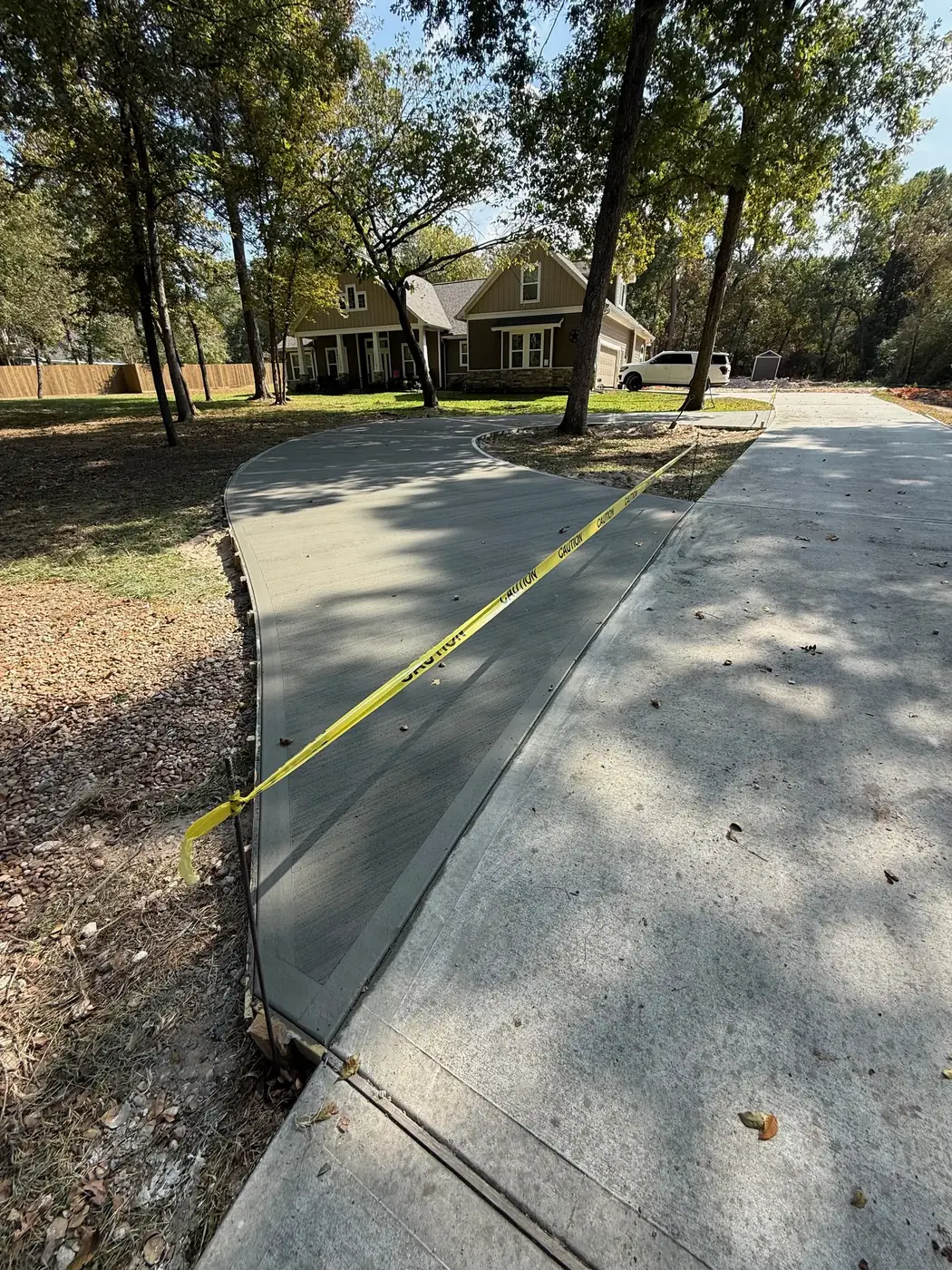 Curved residential concrete driveway and walkway after fresh pour