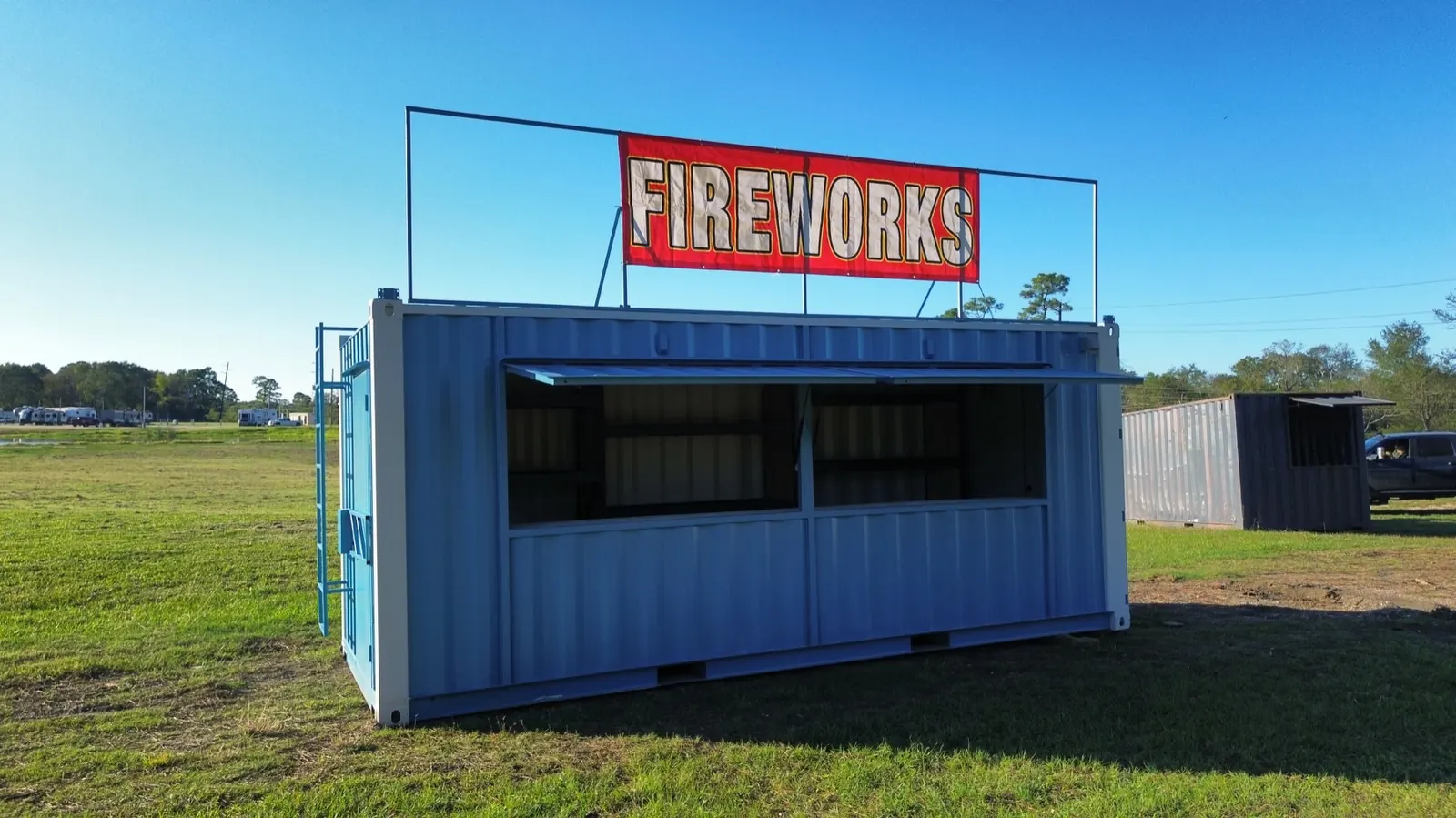 Blue shipping container fireworks stand with signage by ForgeX Industries