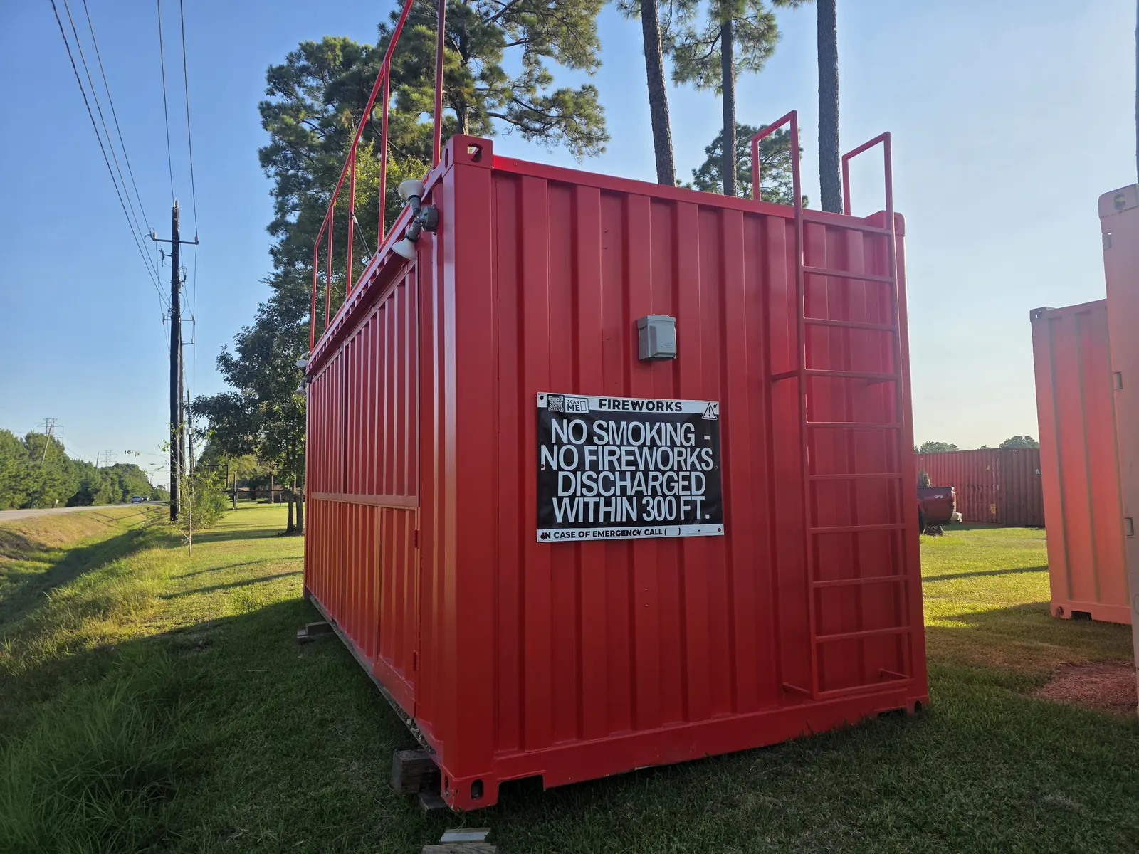 Red shipping container fireworks stand with no smoking safety sign
