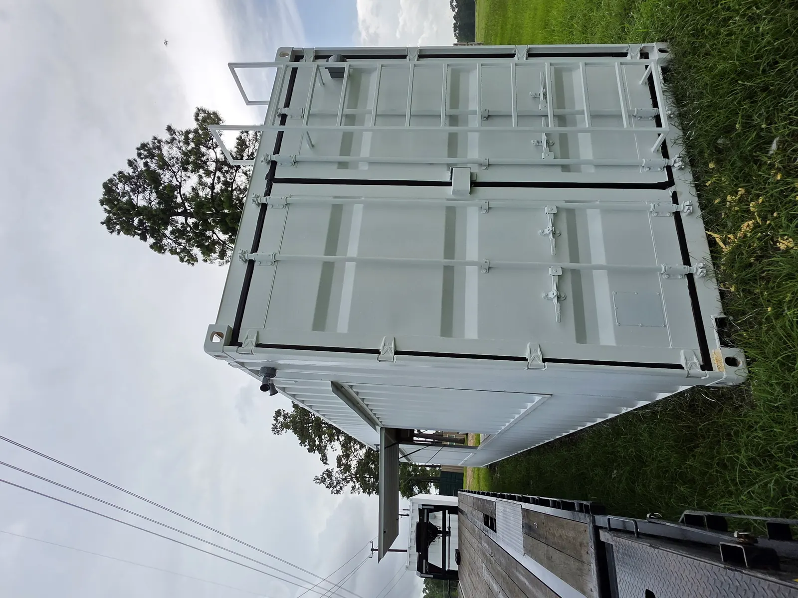 White fireworks stand container with service windows and access framing