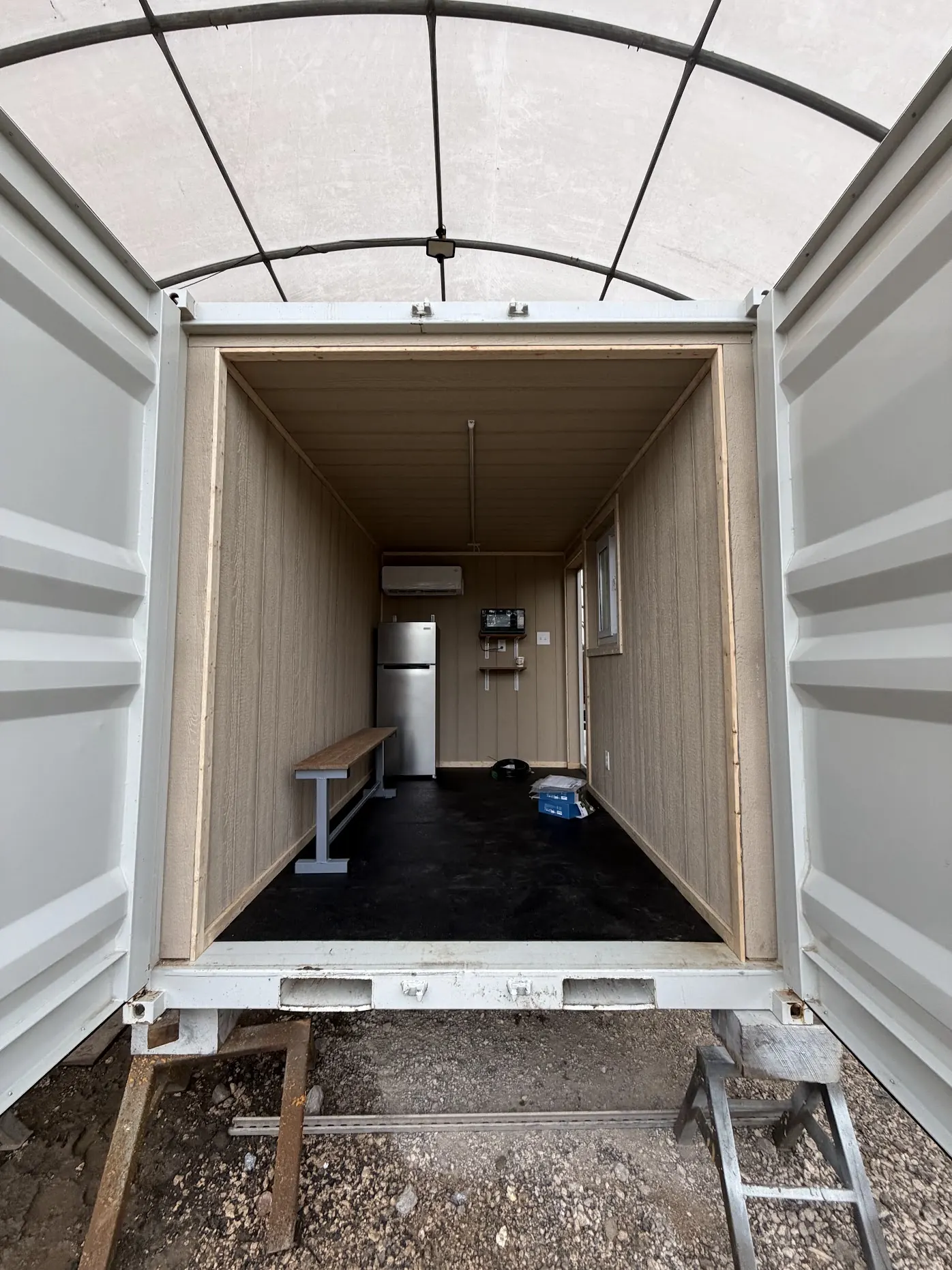 Container interior with bench seating during buildout